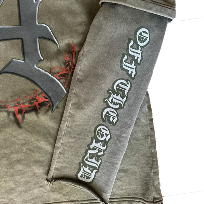 Close-up of the distressed sleeves effect and "Off The Grid" branding text printed on the sleeve.