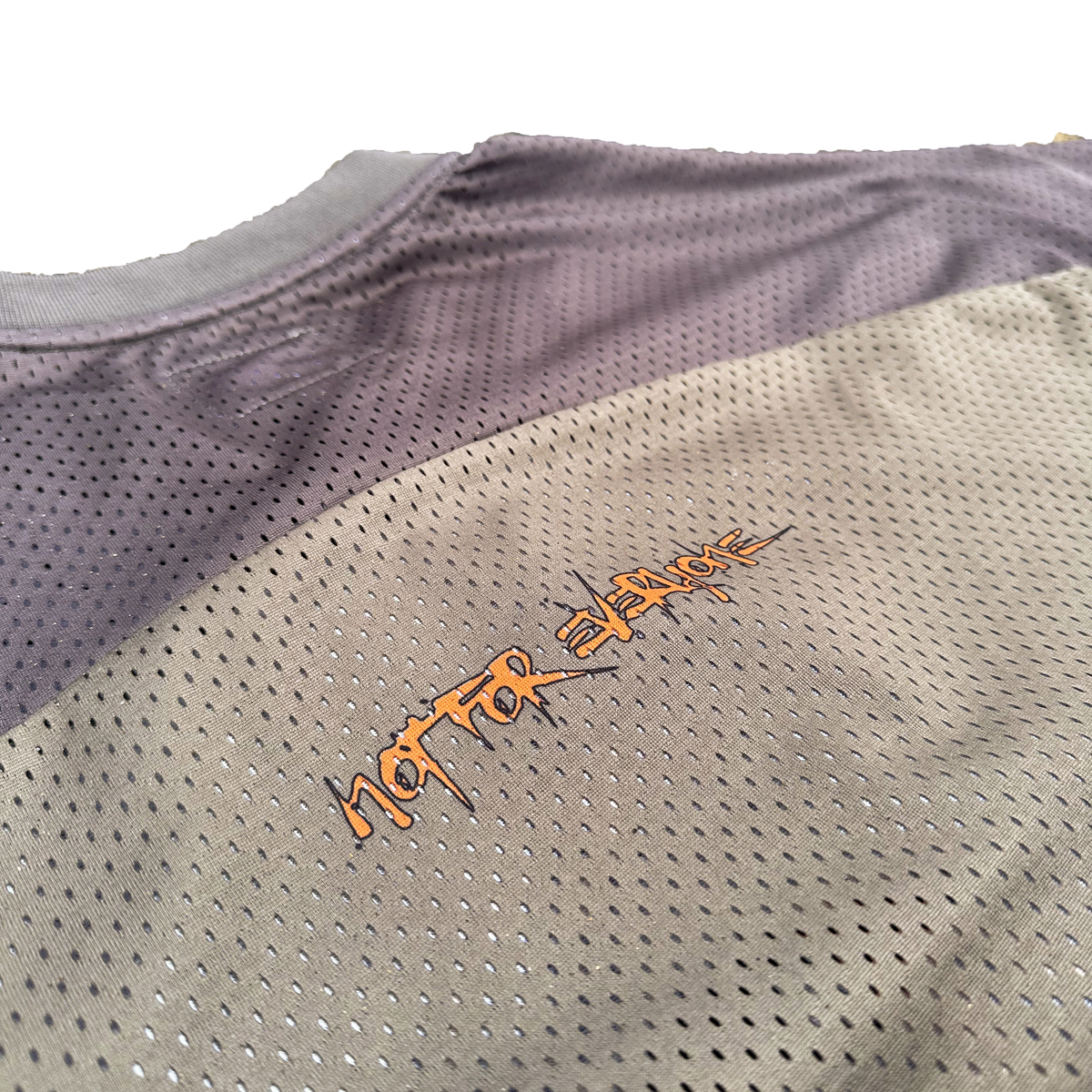 Close-up of the "Not For Everyone" and ribbed fabric details on the Off The Grid jersey.